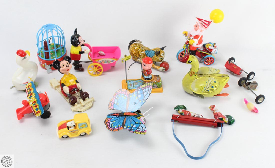 13Pcs Disney VINTAGE AND ANTIQUE CHILDRENS TOYS Mickey: Details: 13Pcs. This lot comprises vintage and antique children's toys. Examples include: Disney Mickey Mouse pushing wheelbarrow; Motorized tin toys; Circus Plane; Snoopy Car; Tin roosters, Santa Cl