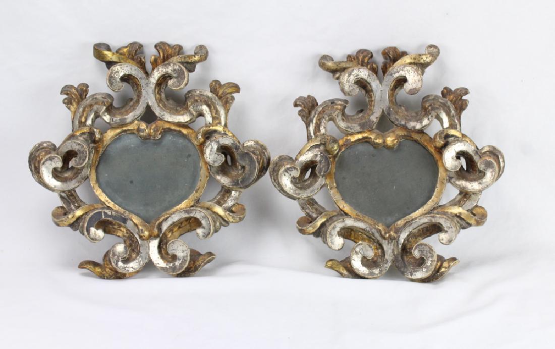 2Pcs Antique GOLD AND SILVER PAINTED CARVED WOOD SACRED: Details: This lot consists of 2 matching Late 18th or early 19th century wall mirrors. Each is gold and silver painted carved wood in a sacred heart shape. They measure approximately 14" in height and