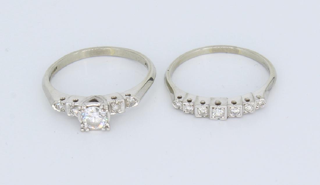 2Pcs Engagement 18K WHITE GOLD WEDDING RING SET: Details: This lot consists of a 18k White Gold ladies Engagement and Wedding Band set from an estate. The engagement band has 4 diamond chips and a larger center stone (perhaps .25 caret). The wedding