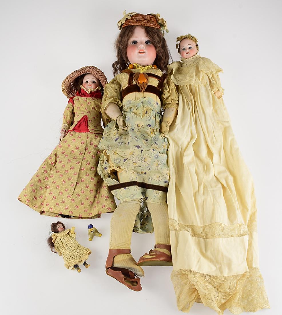 5Pcs Vintage and Antique PORCELAIN HEAD DOLLS Glass: Details: This lot consists of five vintage and antique porcelain head dolls Three of the dolls have glass eyes and several have clothing that appears hand made. One as rare wire spiraled hair. The lar