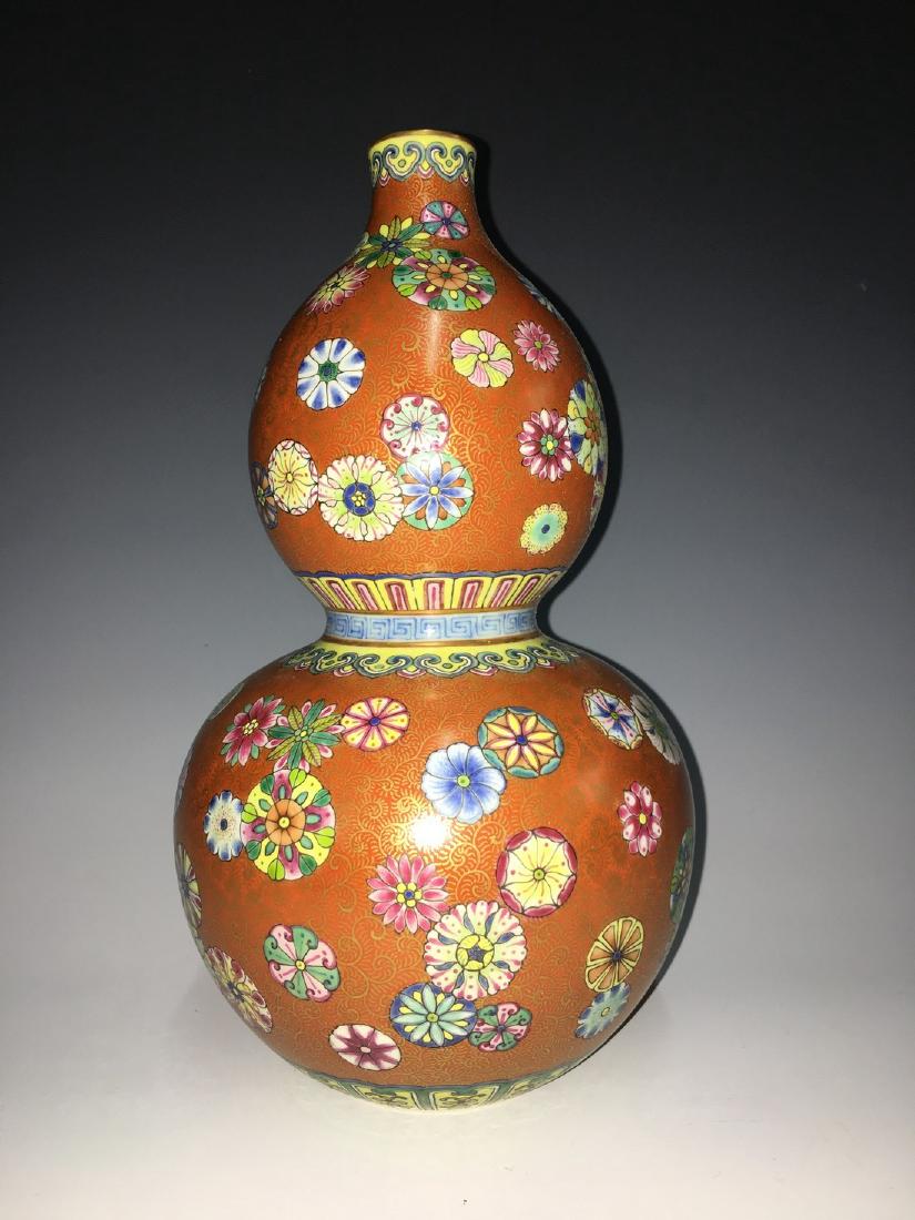 A CORAL-RED-GROUND AND FAMILLE ROSE 'FLOWER BALL' VASE (1 of 3)