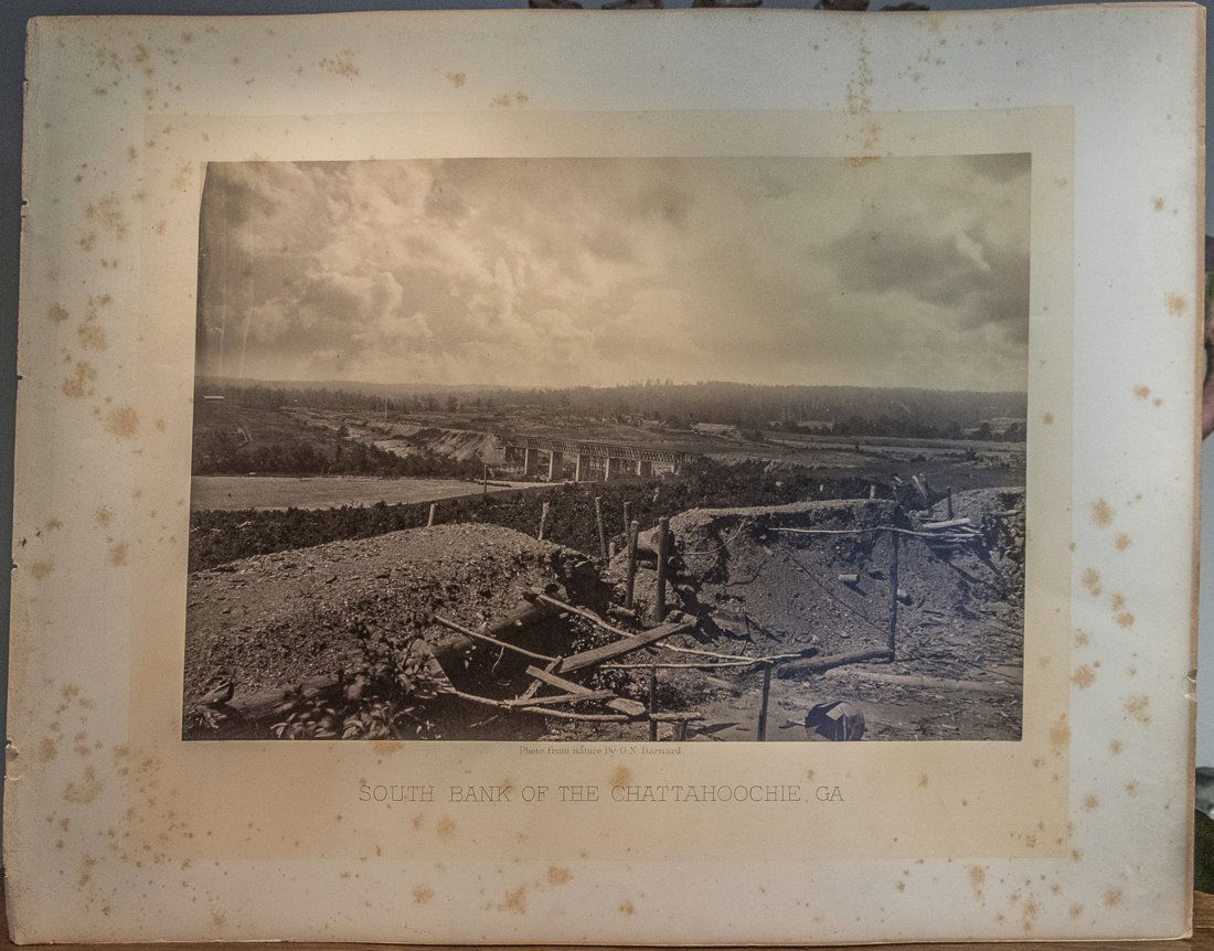 BARNARD CIVIL WAR ALBUMEN OF CHATTAHOOCHIE, GA: A rare albumen photo from nature by George N Barnard of "South Bank of The Chatahoochie, GA." The page measures 16 by 20 inches with the photograph 10 by 14 inches.This is a large paper print, so spec
