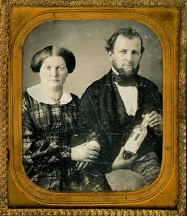 [Daguerreotype] He Holds a Bottle of Hyposulfite: Anonymous, sixth-plate daguerreotype in a full pressed leather case depicting a man and wife. She casually loops her one arm through his while he displays a glass-stoppered bottle labeled