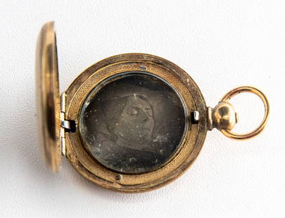 [Daguerreotype] An Unusual Daguerreian Keepsake: A close post-mortem portrait of a middle-aged woman, housed in a gold filled locket. In our experience, an atypical format for this genre. 1 ¼" in diameter. NO RESERVE