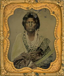 [Tintype] Scarce Portrait of a Pawnee Brave: Anonymous sixth plate housed in a pressed leather case, probably late 1860s or early 1870s. The studio portrait depicts a young Pawnee man in a woman's cotton blouse of the type favored by the men of