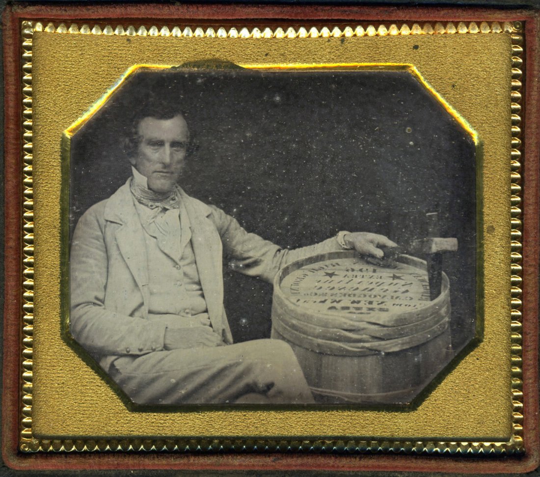 A BARREL OF GENESEE EXTRA SUPER FINE FLOUR: Sixth pate daguerreotype. Full split case. A man cradles a barrel of Extra Super Fine Flour from Genesee, New York. Laterally reversed. RESERVE AUCTION.