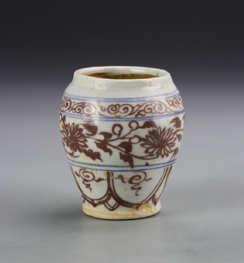 Chinese Blue and Red Miniature Jar: China, 19th C., blue and red miniature jar, with a high shoulder, tapering to the base, and stylized floral motifs across the surface. Height 3 in.