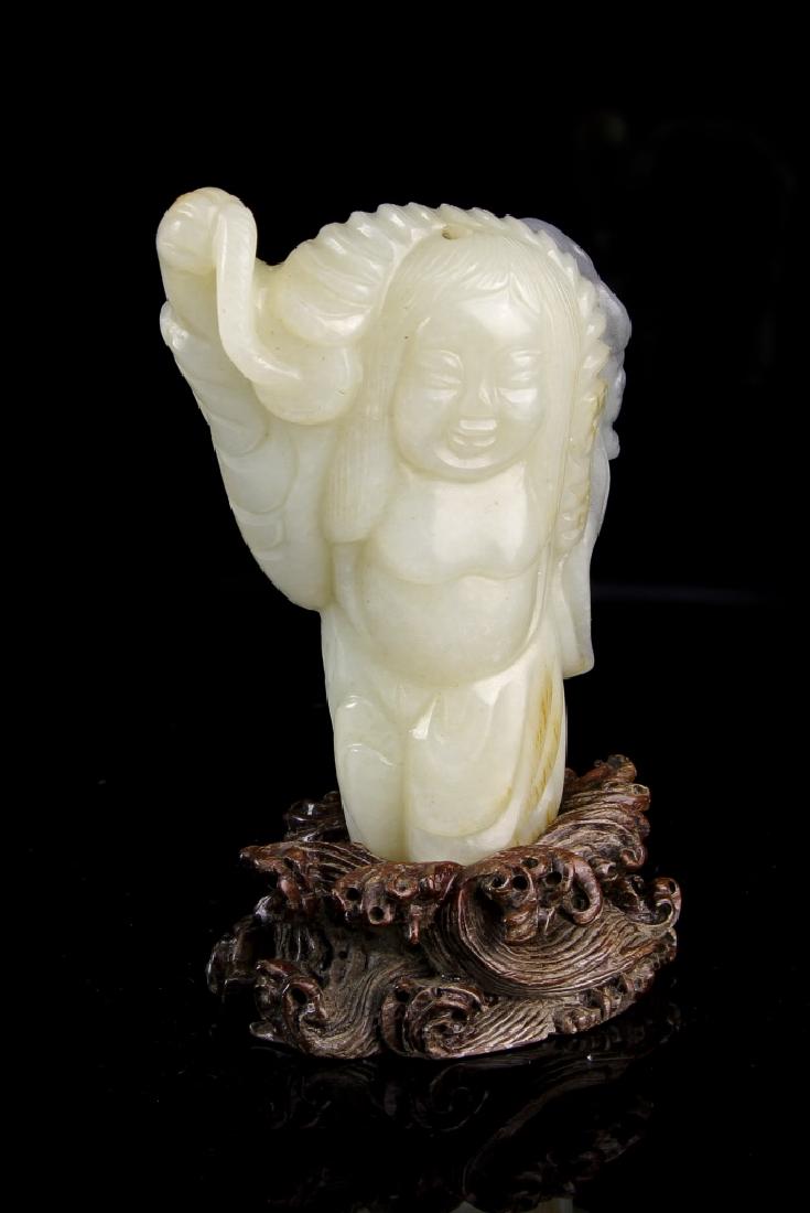 Chinese Jade Liu Hai Figure: China, jade Liu Hai figure, in standing position, with one arm raised, holding an object, with smooth surface, in a light green hue, and carved wood base. Height 3 in. Provenance: From private jade co