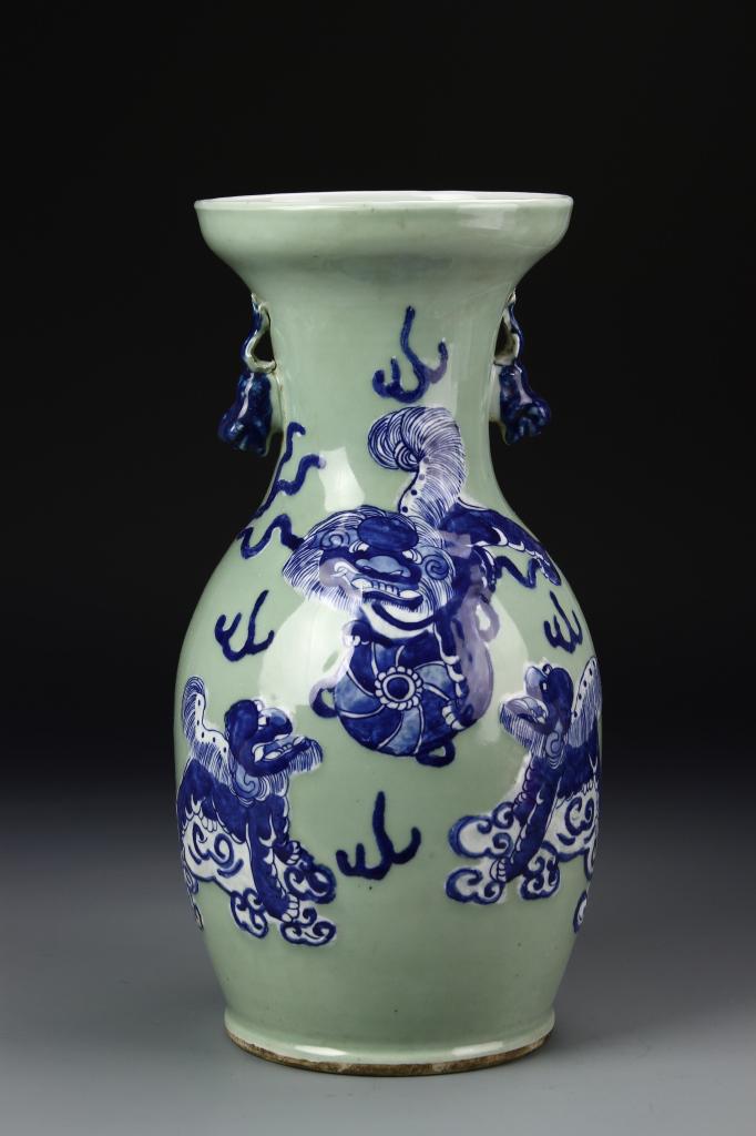 Chinese Blue and White Vase: China, 19th Century, export blue and white vase, on a flat base, with round shoulders, and an inward sloping neck, decorated with raised images of foo dogs, in blue, over an off-white glazed ground. H