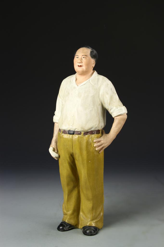 Chinese Chalk Wear Statue of Mao: Chinese, chalk wear statue of Mao, standing and wearing a loose white shirt with dark brown belt and green, beige trousers with a large straw hat draped at his back. Height 16 in.