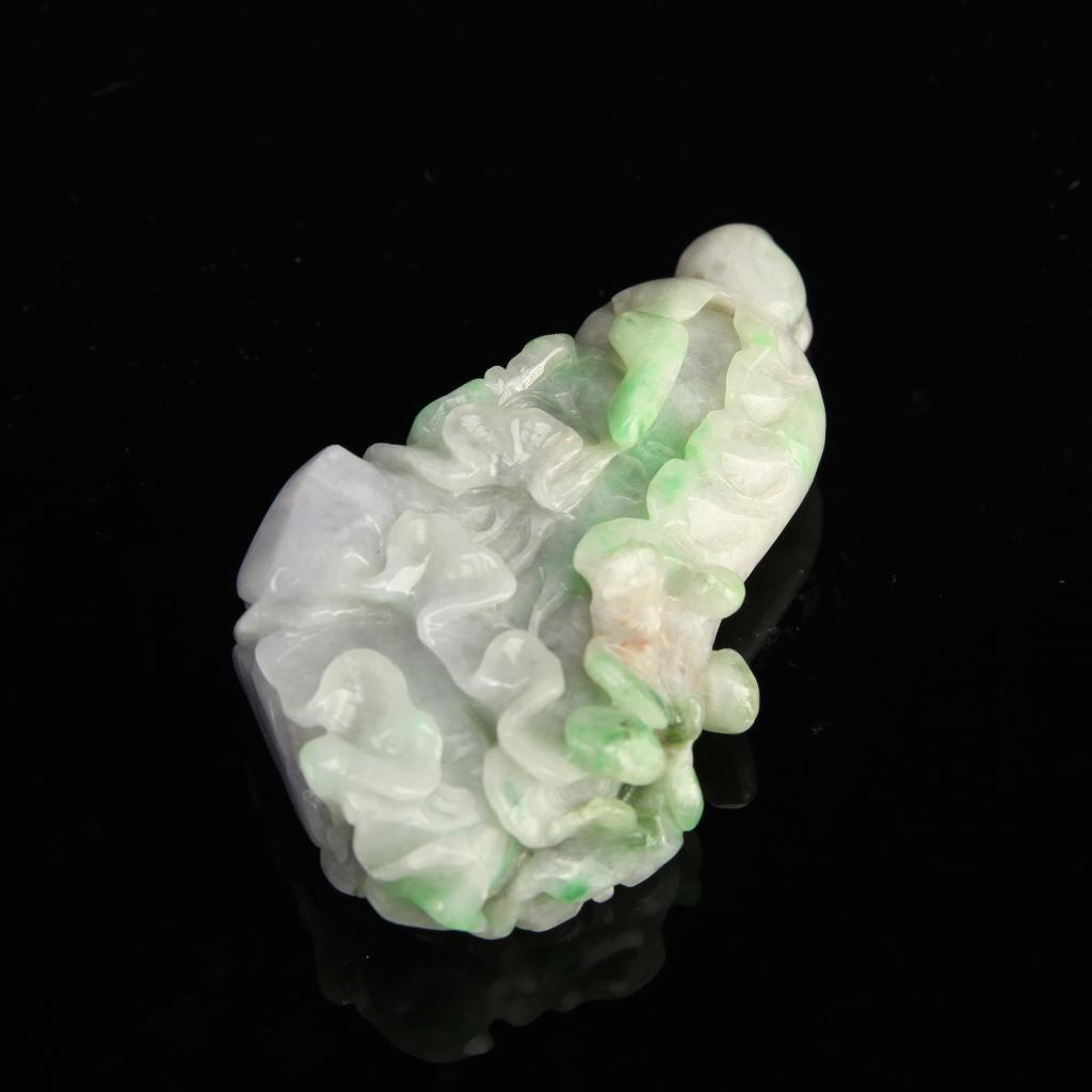 Chinese Jadeite Pendant: China, jadeite pendant, in organic form, with undulating surface pattern, intricately carved, in light purple and bright green mottled hues. Height 2 1/4 in.
