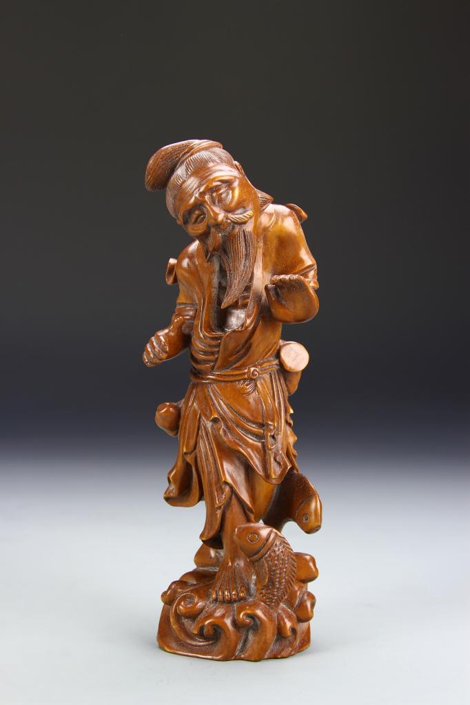 Chinese Boxwood Luohan: China, carved boxwood Luohan, expertly carved wooden figure of a bearded man standing on a wave, richly hued brown and hazel tones. Height 7 in.