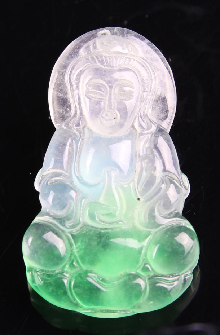 Chinese Jadeite Guanyin Pendant: China, jadeite Guanyin pendant, polished surface, seated figure, in a flowing robe, deep green visible in base, fading to a translucent hue. Height 1 1/4 in.