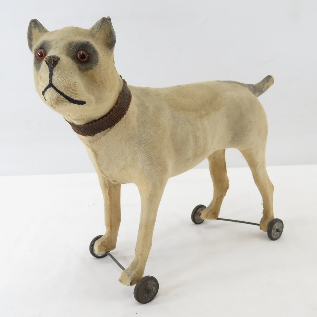 Antique Paper Mache Fabric Covered Dog Pull Toy: glass eyes, wooden feet, metal rollers, rattles inside- may have been a growler. All antique items have wear consistent with age please review all photos, and please read terms & conditions and ask qu