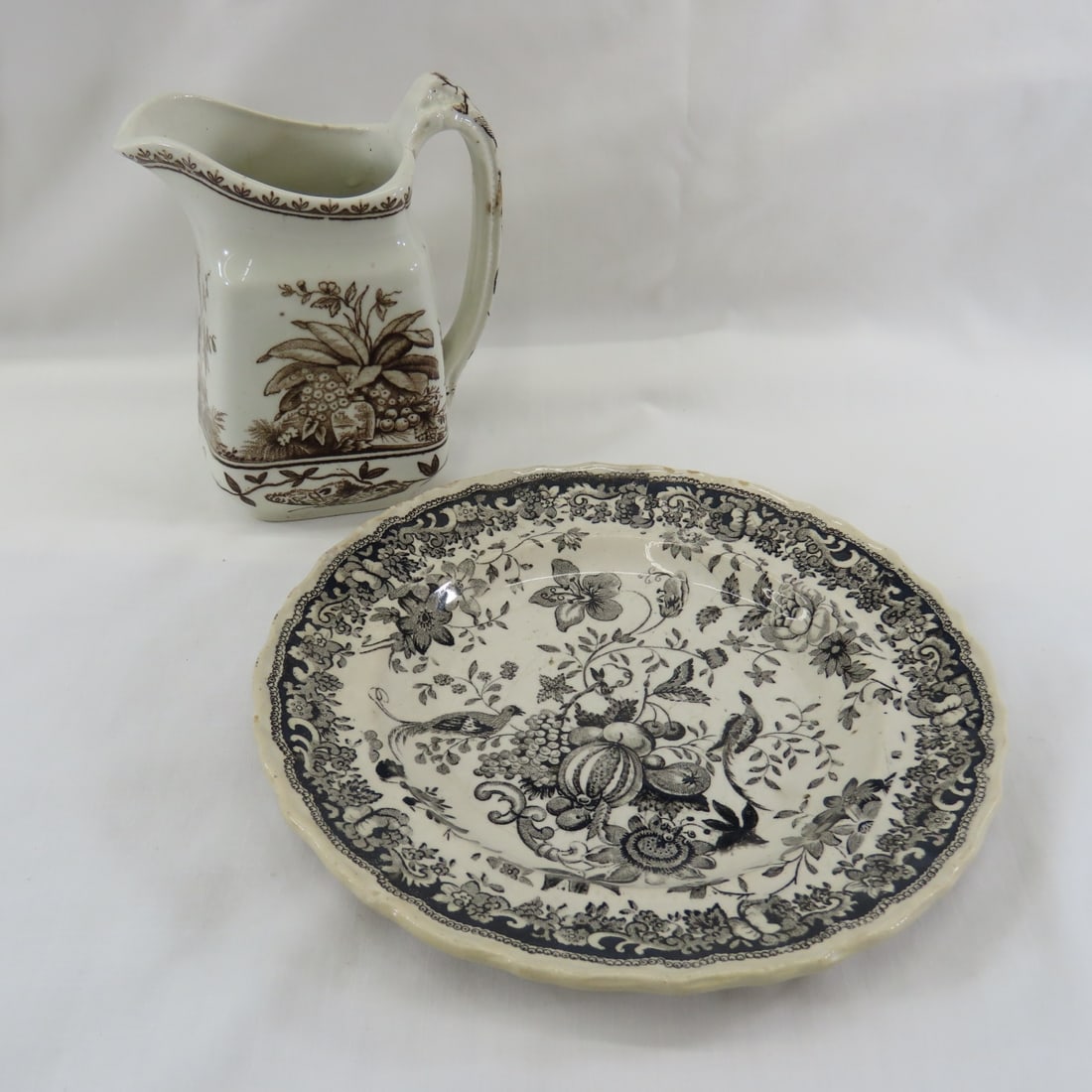 1820's "Birds & Fruit" Plate & Brown Creamer: "Birds & Fruit" 7" Black Transferware Plate Lowndes & Beech C.1821-1834- minor chips on edge. Unmarked 4" creamer with large plant, vase with castle and moth All antique items have wear consistent wit