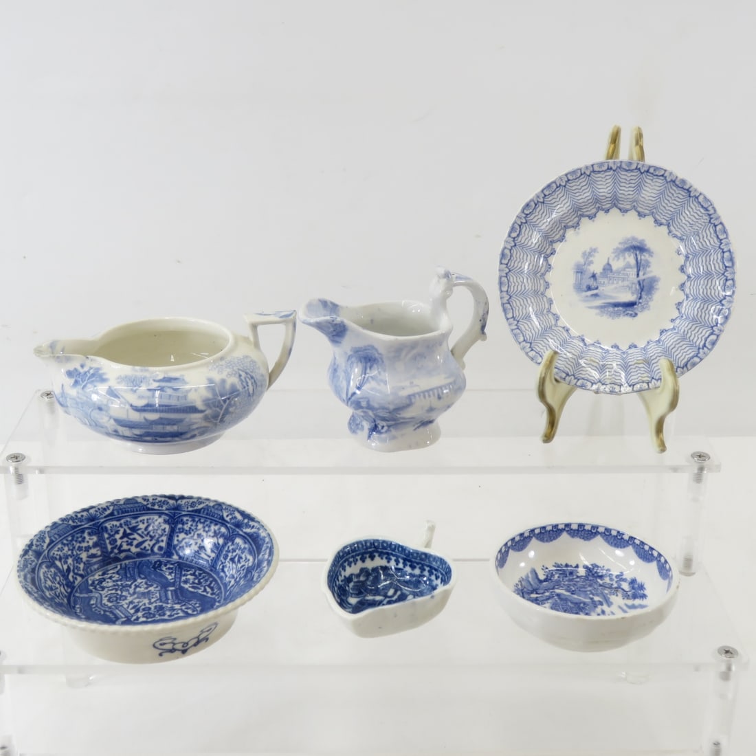 6 Antique Blue Transferware Pieces: 1850's butter pat 4"- diamond registry mark on bottom, 3" bowl- Woods England, 2 x 2.5" leaf shape dish unmarked, 2.5" individual creamer- unmarked, 4 x 1.75" individual teapot (no lid) unmarked, and