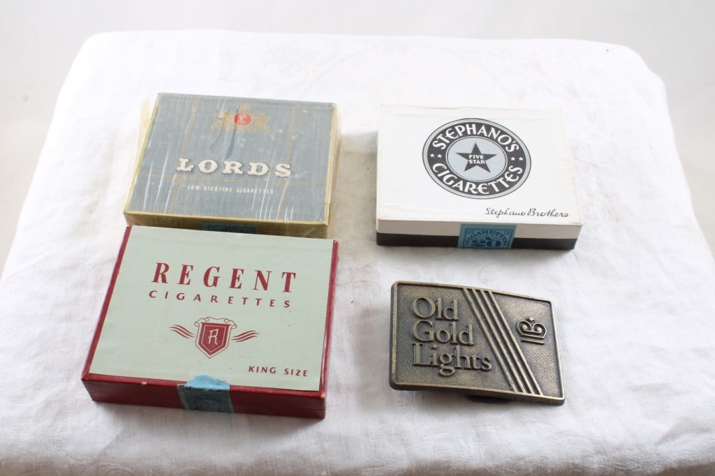 3 Sealed Cigarette Tins & Old Gold Belt Buckle: 3 Sealed Cigarette Tins & Old Gold Belt Buckle- Regent Cigarettes King Size Sealed, Lords Low Nicotine Cigarettes sealed, Stephano's Cigarettes Sealed and Old Gold Lights Belt Buckle as pictured. Plea