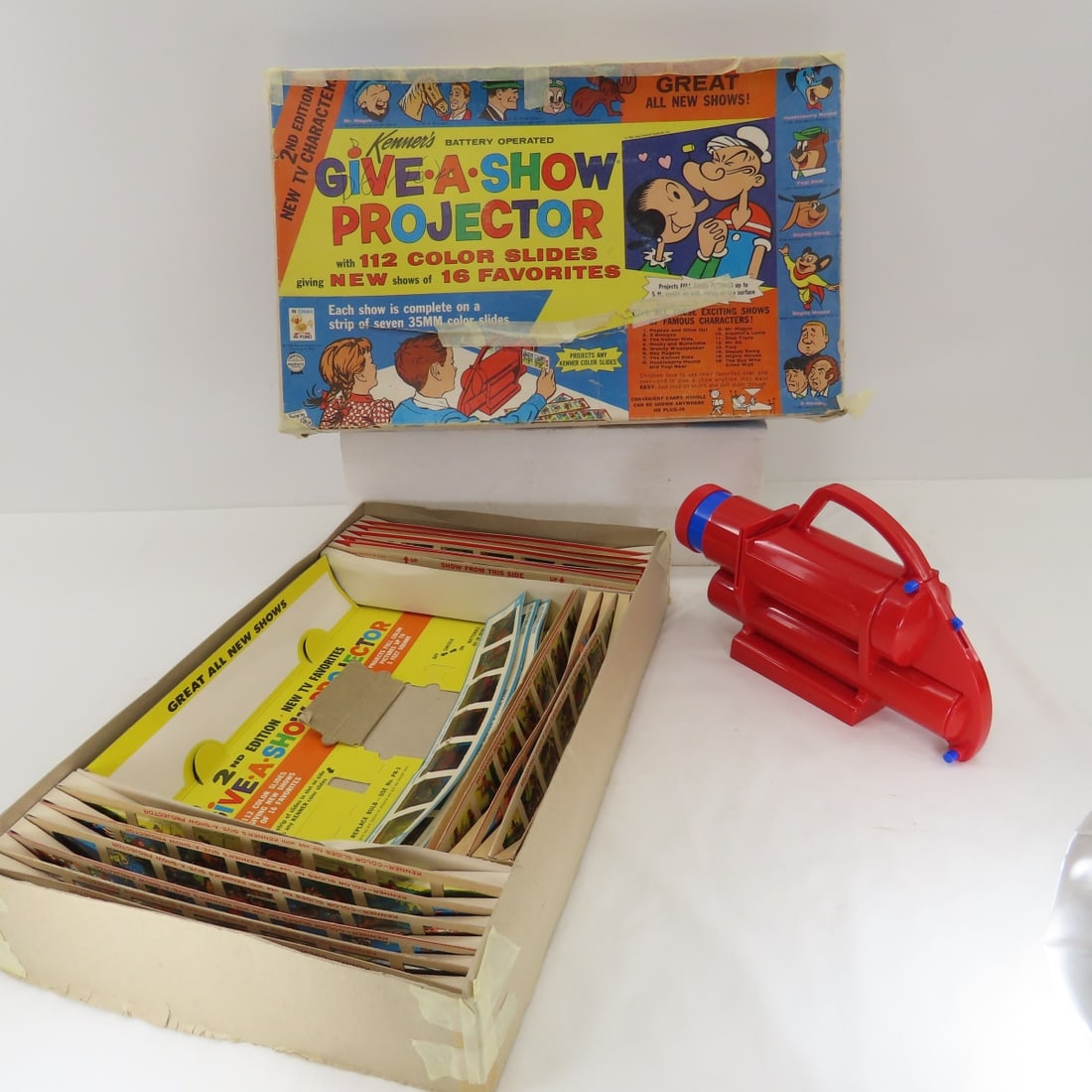 Kenner Give-a-Show projector - WORKS- Complete: has all 16 strips plus 3 extras Please ask questions and read terms & conditions before bidding.