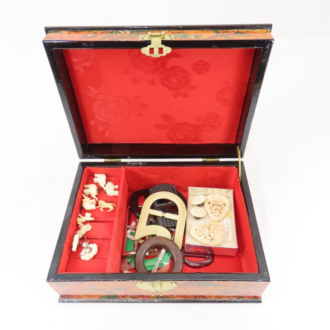 Vintage Belt Buckles, African & Other Jewelry: Vintage Belt Buckles, African & Other Jewelrycarved bone charms, earrings, and clips, some plastic, in box made in China 9x6x3.5" Please ask questions and read terms & conditions before bidding.