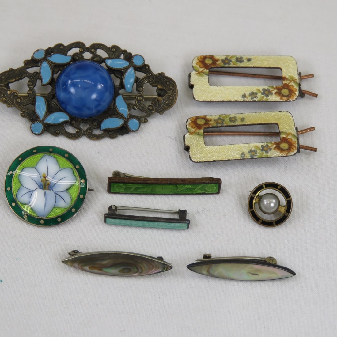 Enamel, Bermuda Sterling Guilloche, & Other Pins: Enamel, Bermuda Sterling Guilloche, & Other Pinsand a pair of barrettes Please ask questions and read terms & conditions before bidding.