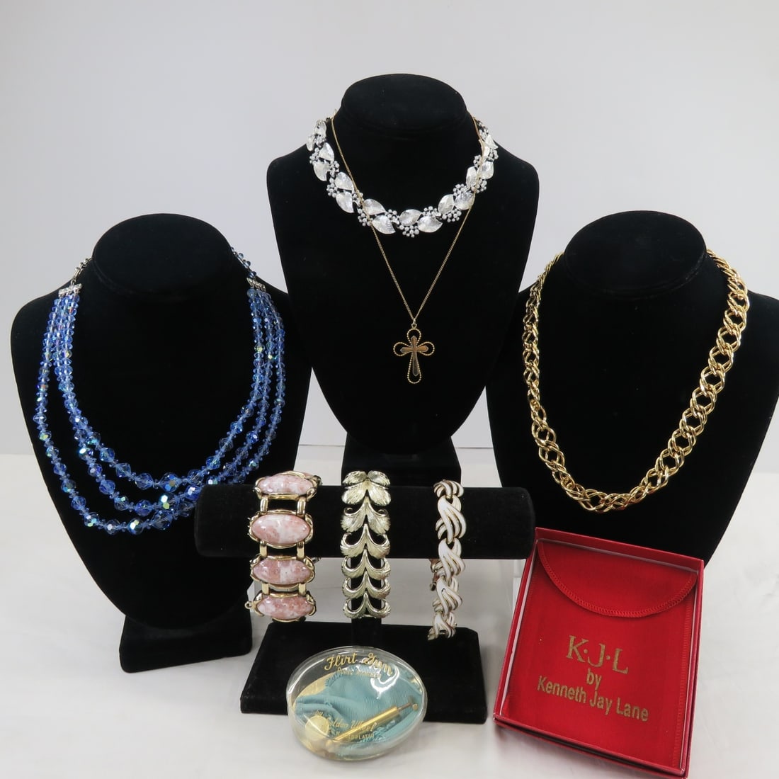 KJL, Lisner, Trifari & Other Vintage Jewelry: KJL, Lisner, Trifari & Other Vintage Jewelry1) signed KJL 20" large chain in pouch & box, 2) Trifari white enamel bracelet with safety chain, 3) Lisner gold tone bracelet, 4) Lisner silver tone choker