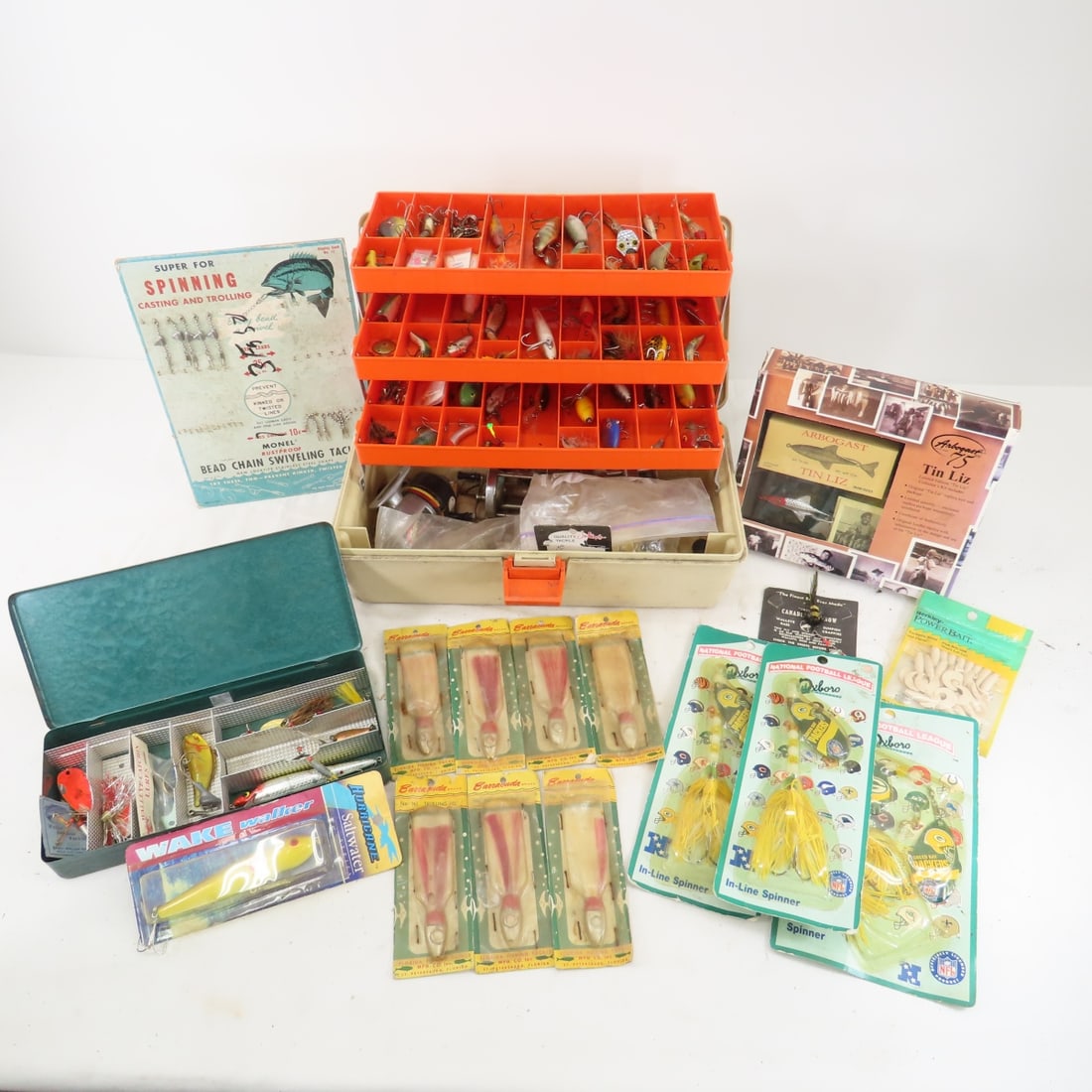 Vintage tackle boxes and fishing lures, some NIP: Vintage tackle boxes and fishing lures, some NIPArbogast Tin Liz repo in pack, Spinning lures on display card, 3 Green Bay Packer's lures, jig's on cards, 20 misc lures, reels and more Please ask ques