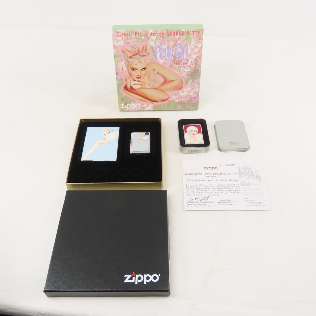 Zippo Petty Girl & Series II Lighters in tins, new: Zippo Petty Girl & Series II Lighters in tins, new Please ask questions and read terms & conditions before bidding.