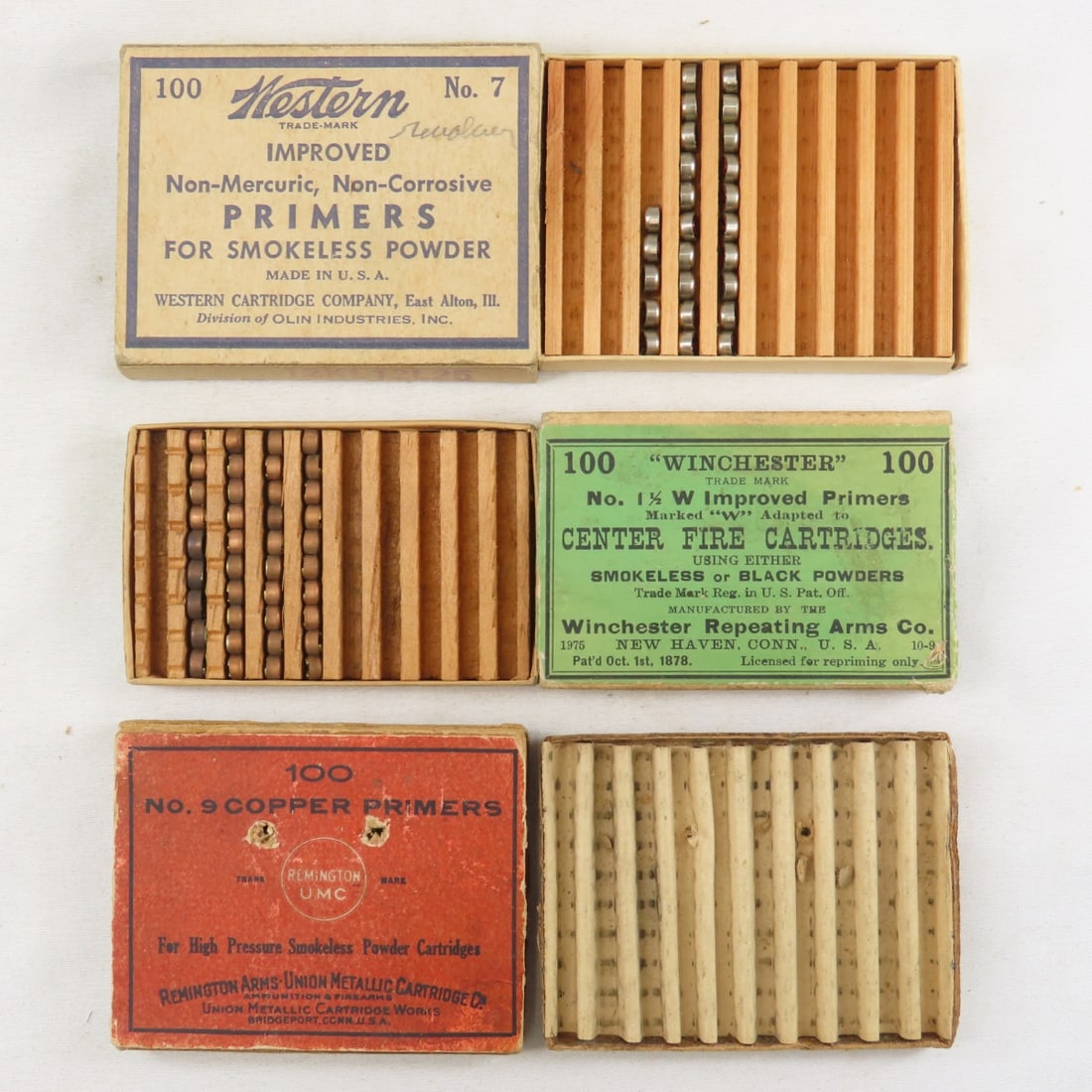 3 Antique Primer Boxes & Some Primers: Winchester No. 1 1/2 box in very good condition with approx 40 primers. Western No 7 box in very good condition (pencil writing) with approx 25 primers. Remington UMC No. 9 Copper primers box-empty. a