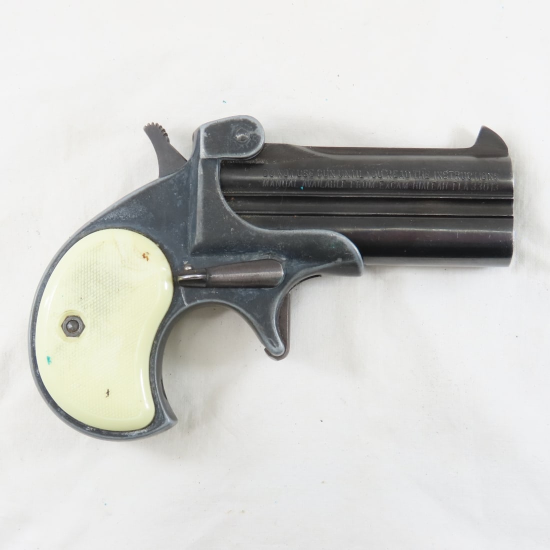 Excam Model TA 38 cal .38 SP Derringer: imported Hialeah Fla, 3" barrel over / under, plastic checkered grips, serial #L69563, discontinued 1985 Overall fair condition- some rusting on outside of barrels. FFL transfer required, please know 
