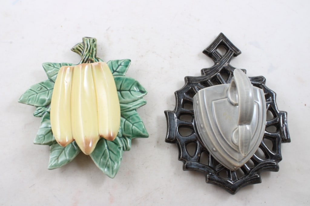 2 McCoy Pottery Wall Pocket Planters: Bananas & Trivet with Sad Iron. Trivet with Sad Iron has a repair at the top trivet hanger. Both as pictured. Please ask questions & read terms & conditions before bidding.