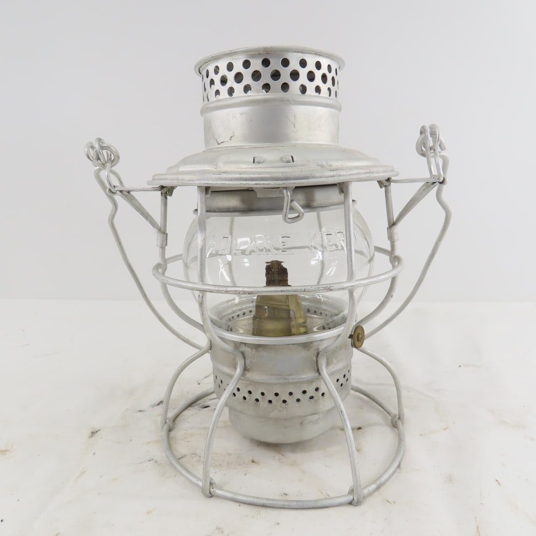M&STL Adlake 250 Short Clear Glass Lantern: bend to base frame. From the Collection of Don L. Hofsomer. Please ask questions and read terms & conditions before bidding.