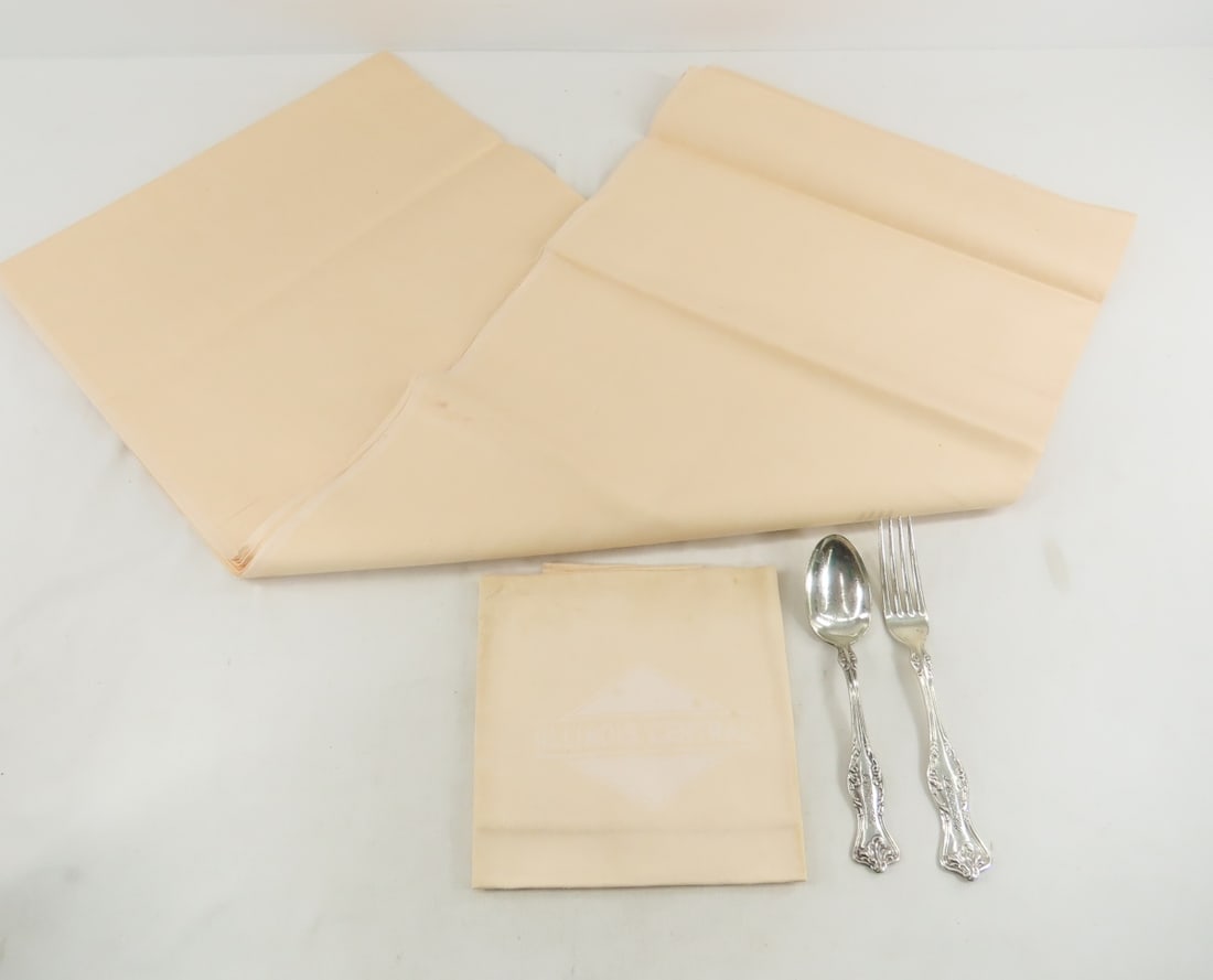 Illinois Central Flatware, Tablecloth & Napkin: 72x 56" peach tablecloth- still has sticker- like new, and matching napkin (dirty). Meriden Brita Co Westfield pattern fork & spoon top marked "ICRR Co" in cursive. From the Collection of Don L. Hofso