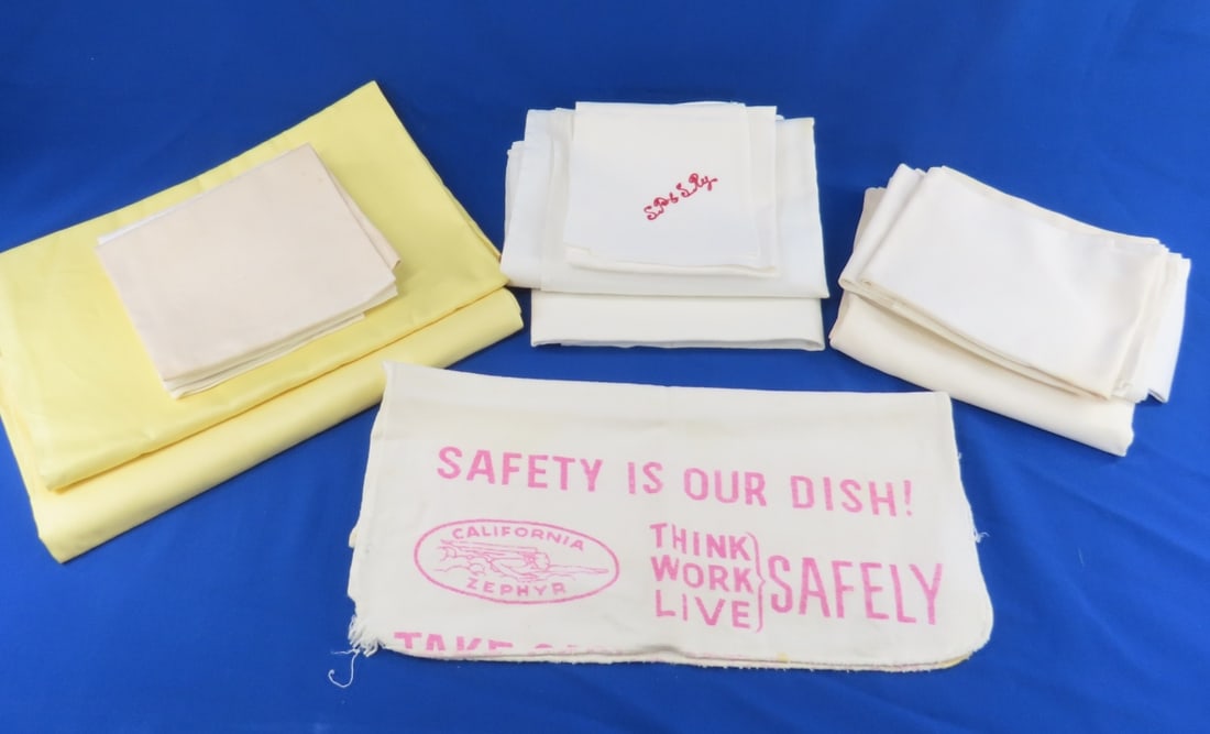 Assorted Railroad Linens: 2 Yellow "City of San Francisco" tablecloths - like new, CA zephyr safety towel & 3 white napkins, 2 white FRISCO tablecloths (stains), 4 L&H napkins (stains), SP&SRY stitched napkin, ROCK ISLAND tabl