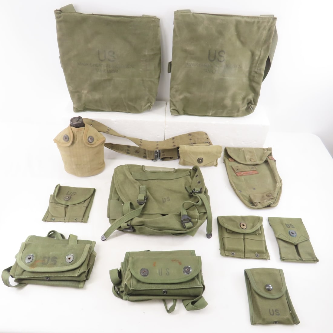 US Military canvas items, canteen on pistol belt: US Military canvas items, canteen on pistol belt-ammo pouches, bags, chemical mask bags & more Please ask questions and read terms & conditions before bidding.