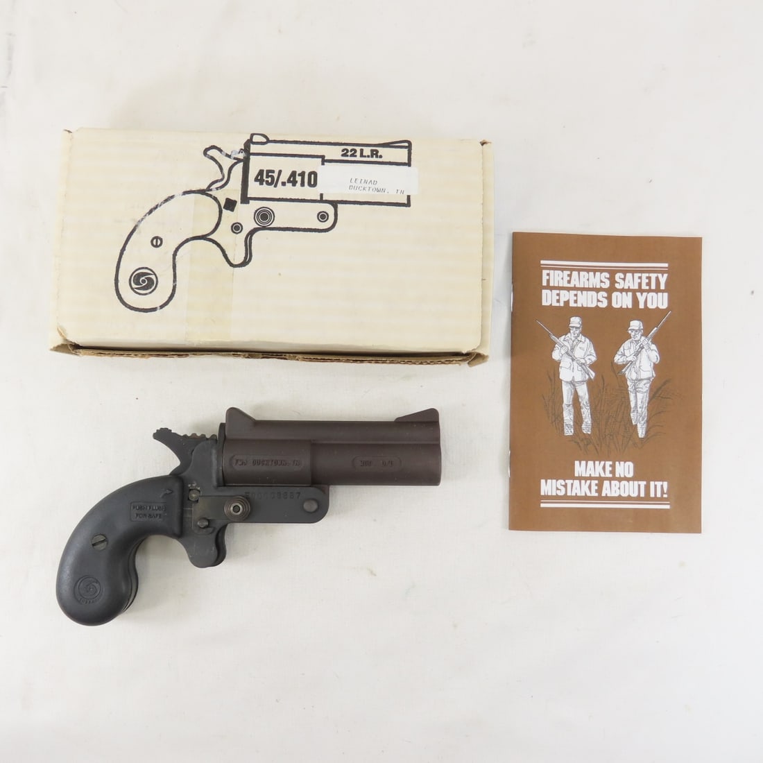 Cobray O/U 22lr 45LC/.410 Derringer NIB: Cobray O/U 22lr 45LC/.410 Derringer NIB - Leinad FMJ Ducktown import, serial number E00008887, top break, 3 3/4" barrel. FFL required. Please know local laws before bidding. Please read terms & condit