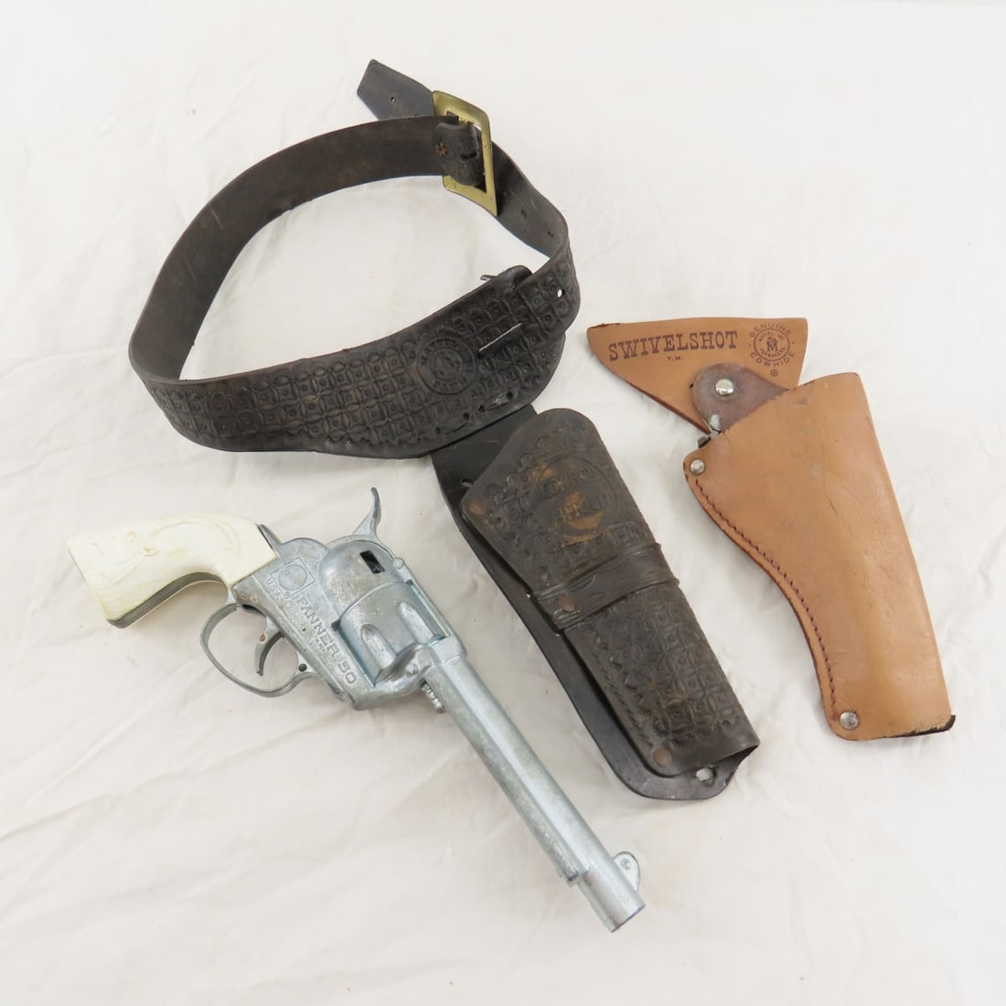 Vintage Mattel Fanner 50 Cap Gun & 2 Holsters: Vintage Mattel Fanner 50 Cap Gun & 2 Holsters - Original single leather Mattel Swivel holster- no belt. plastic cowboy in Africa holster belt, Antelope grips, functioning. finish is dull Please ask qu
