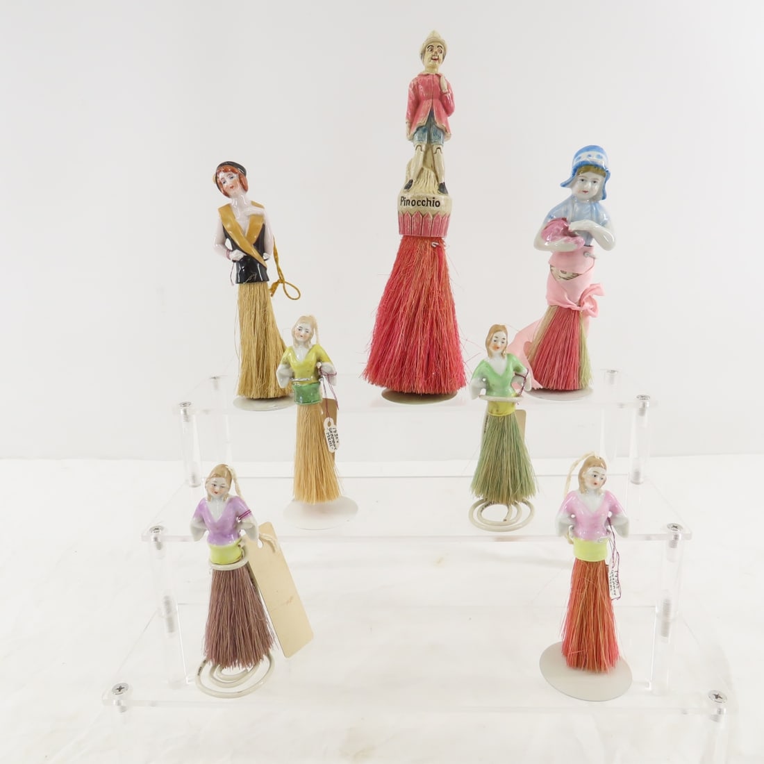 7 1920's 1930's Half Doll Whisk Brushes & Stands: 7 1920's 1930's Half Doll Whisk Brushes & Stands -Tallest is 9" Please ask questions and read terms & conditions before bidding.