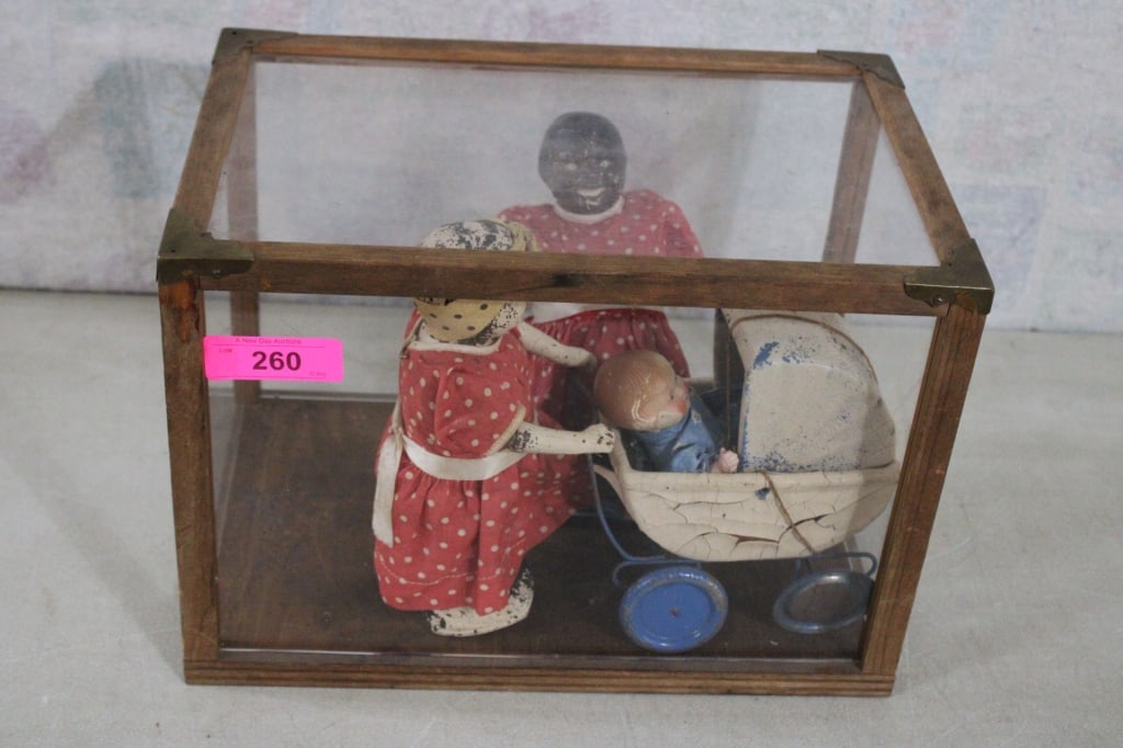 Black Americana Dolls w/Baby/Buggy Pull Toy: Black Americana Dolls w/Baby/Buggy Pull Toy - Mammy's are Walkers, Baby & Buggy are all made of Composition and show wear. All are in glass, wood & brass display case that measures 15 1/2" x 10" x 11"