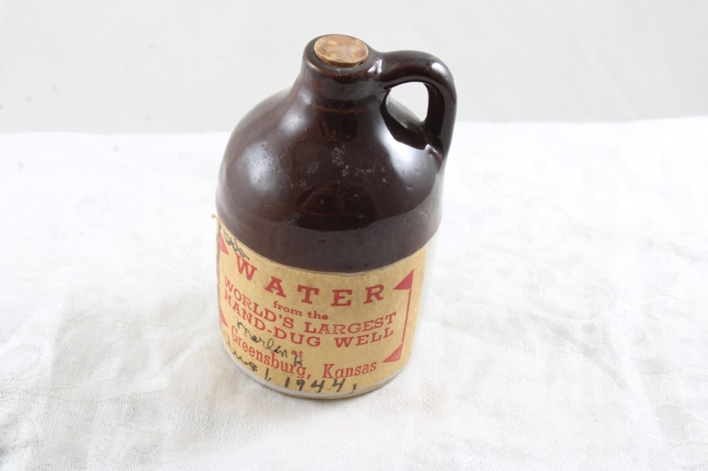 1944 World's Largest Hand Dug Well Water Jug: 1944 World's Largest Hand Dug Well Water Jug - Greensburg, Kansas. Stoneware Jug that measures 3 1/2" Tall. As pictured. Please ask questions and read terms & conditions before bidding.