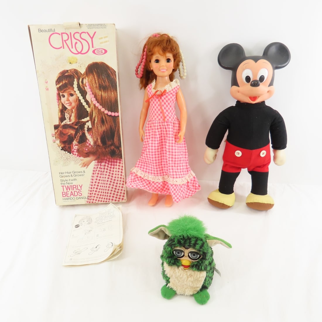 Furby, Mickey Mouse & Crissy Twirly Beads Doll: Furby, Mickey Mouse & Crissy Twirly Beads Doll - Mickey marches by pumping hands- works, Furby green turtle- not working, Crissy hair grow twirly beads- works in original box Please read terms & condi