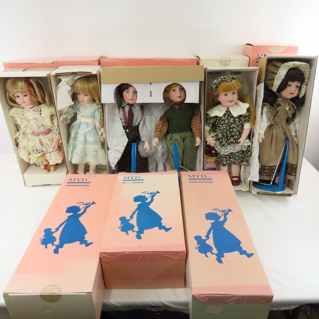 9 Vintage Marian Yu Design Dolls in Boxes: 9 Vintage Marian Yu Design Dolls in Boxes - 8 boxes- 1 is pair - Glen & George. All have been displayed, some boxes were in storage and have wear - some may have water damage. Please read terms & cond