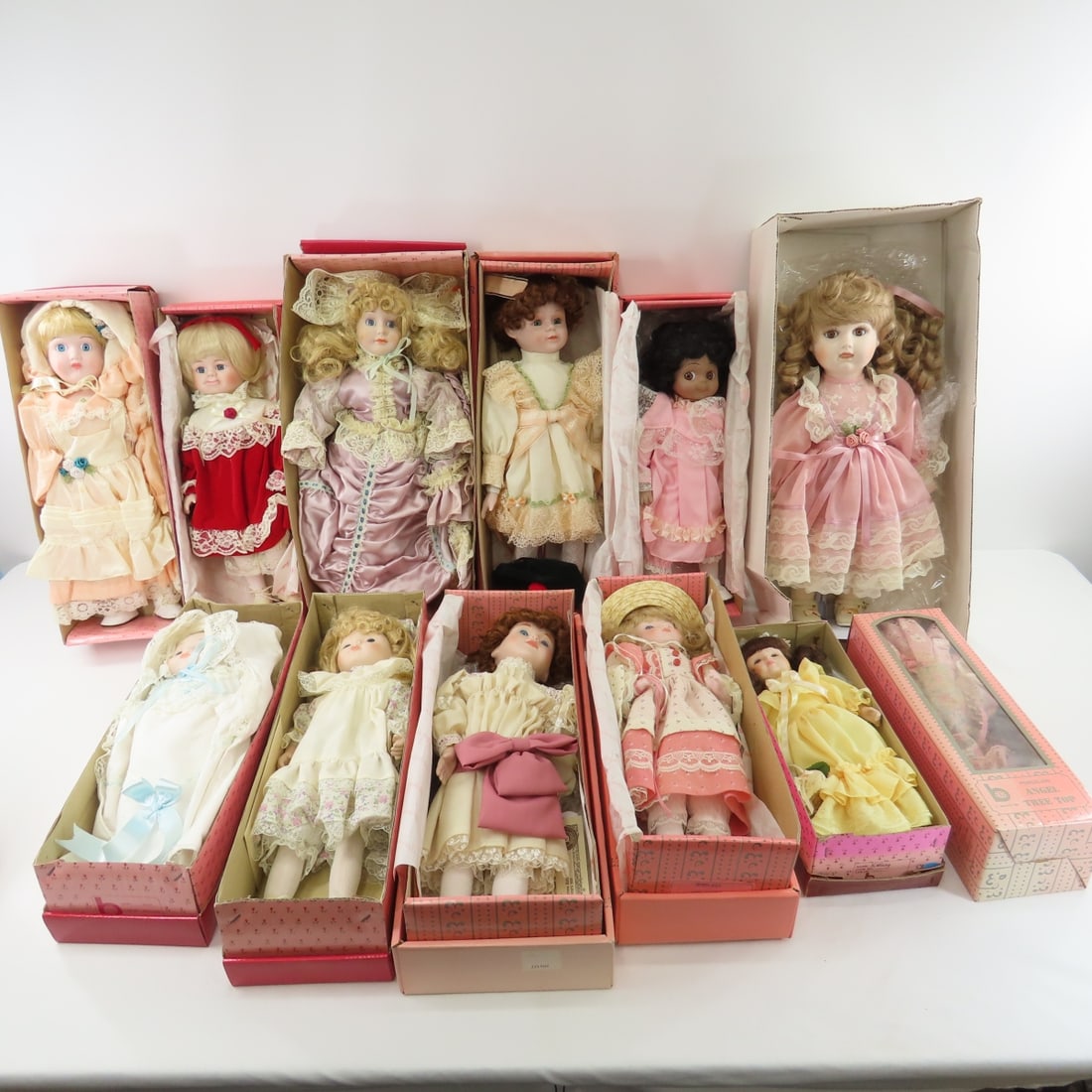 11 Vintage Brinn's Porcelain Dolls in Boxes: 11 Vintage Brinn's Porcelain Dolls in Boxes - All have been displayed, some boxes were in storage and have wear - some may have water damage, 1 is a Barbie Doll, 12 dolls total Please read terms & con