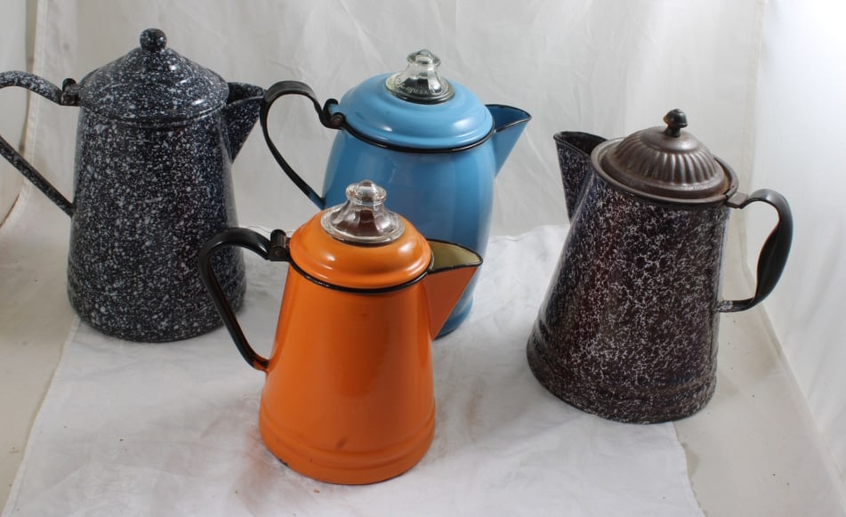 4 Enamelware Coffee Pots: 4 Enamelware Coffee Pots - Orange 9" Tall, Brown Sponge Ware 10" Tall, Blue 10 1/2" has a Pyrex glass top, Navy Spatter Ware 11" Tall. As pictured. Please ask questions and read terms & conditions bef