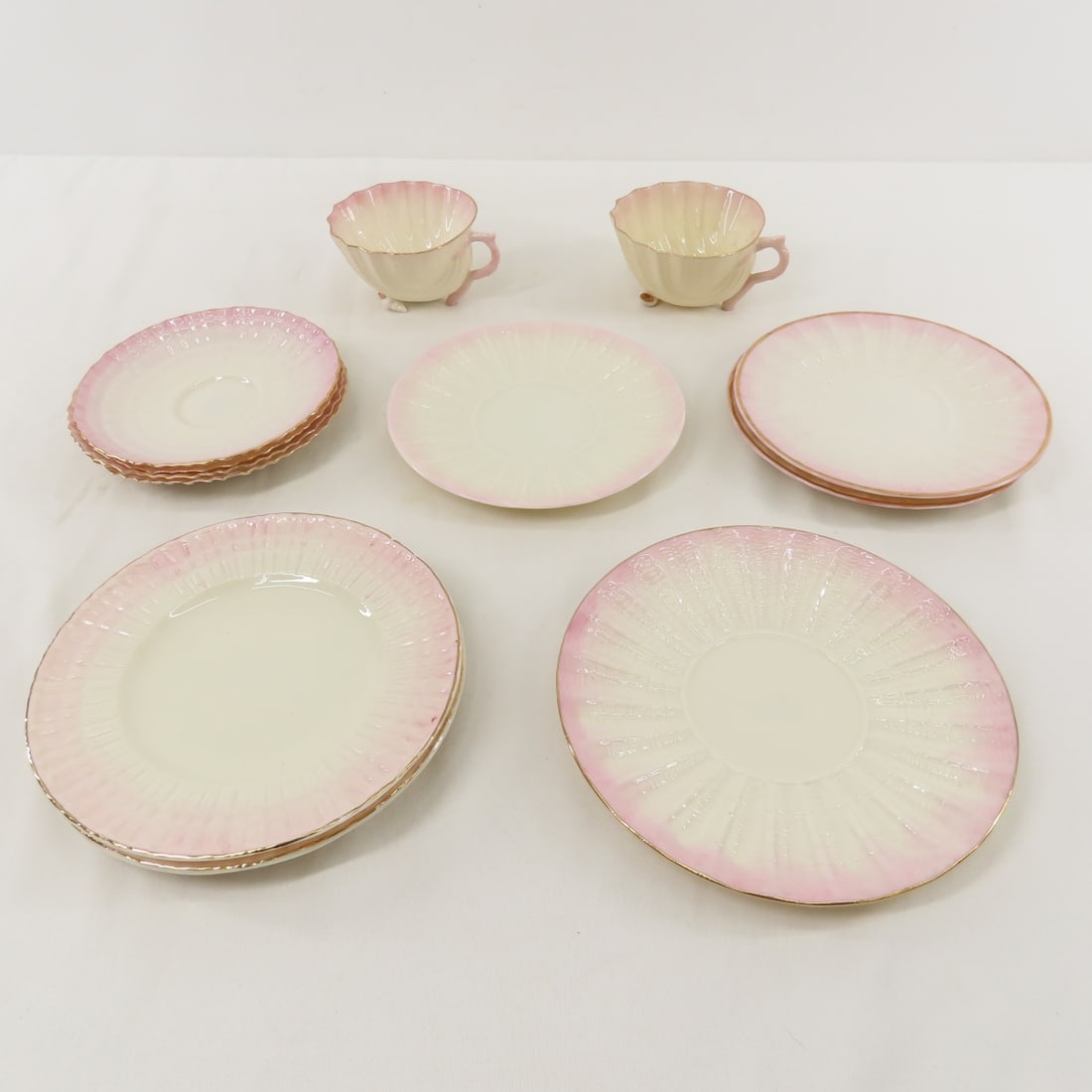 Belleek Limpet Pink Porcelain Cups & Saucers: Belleek Limpet Pink Porcelain Cups & Saucers - 2 cups, 4 saucers, 3 plates 6", 2 plate 6 3/8", 1 plate 6 3/4", no cracks or chips Please ask questions and read terms & conditions before bidding.