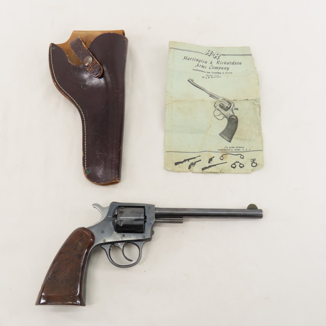 H&R Arms Co H&R 922 .22 Revolver: H&R Arms Co H&R 922 .22 Revolver - SN# J197, manufactured 1927-1982. 8 shot revolver, 6" barrel with blade sight, textured plastic grips, exposed hammer, leather holster, with original instruction gui