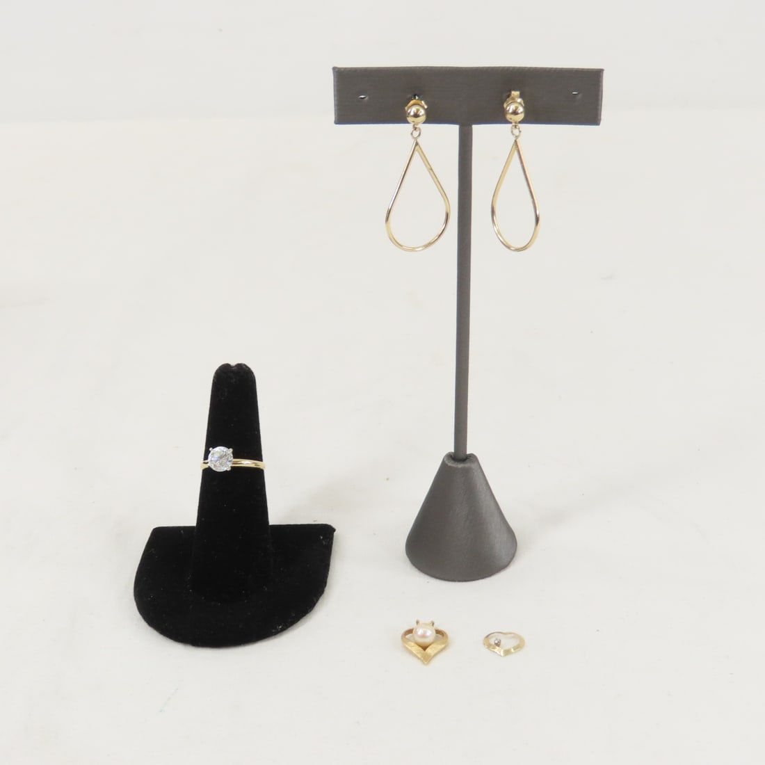 5.0 grams 14kt Yellow Gold Jewelry: 5.0 grams 14kt Yellow Gold Jewelry - 14K DMR ring size 6 - not diamond, 14kt pierced earrings (1 back is bent, 2 heart 14K pendants- 1 with pearl Please ask questions and read terms & conditions befor