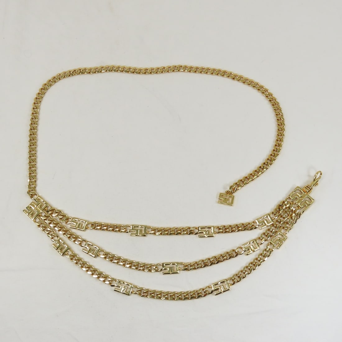 St. John Triple Strand Logo Gold Tone Belt: St. John Triple Strand Logo Gold Tone Belt - Please ask questions and read terms & conditions before bidding.