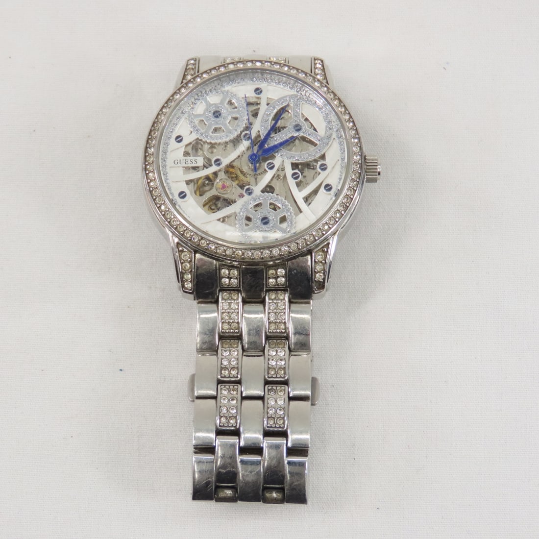 Guess Candlelight Elegance Skeleton Watch U25004L1: Guess Candlelight Elegance Skeleton Watch U25004L1 - working automatic, 40mm, stainless steel, analog with blue hands, 100 meters water resistant, crystal has scratches from wear, crystal accents, fol
