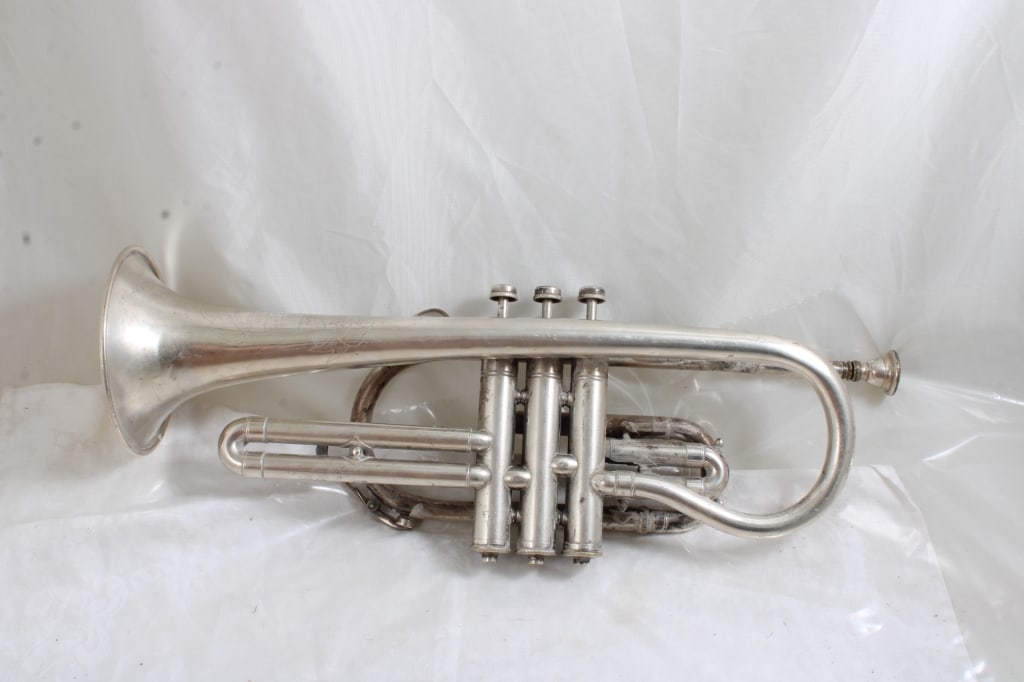 1943 Regent Soloist Cornet Band Instrument: 1943 Regent Soloist Cornet Band Instrument - With Mouthpiece. Serial #28241. As pictured. Please read terms and conditions and askquestions before bidding. Live Auctioneers only shows 20 photos per lo