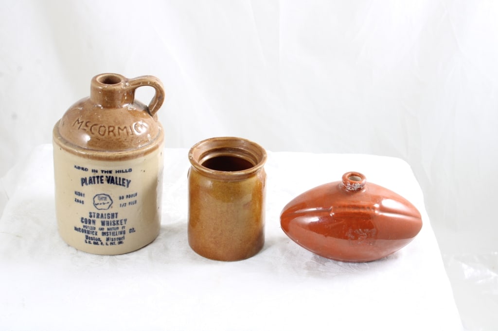 3 Stoneware Crock, Jug, Football Flask: 3 Stoneware Crock, Jug, Football Flask - 5.5" Crock, Platte Valley 5" Tall Jug, Football Flask 4.5" Long. All 3 as pictured. Please read terms and conditions and askquestions before bidding. Live Auct